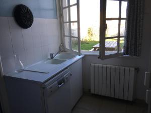 a small bathroom with a sink and a window at FACE A LA MER , L ARTISTE in Ambleteuse +70 photos