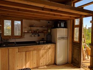 a kitchen with a white refrigerator in a cabin at Barefoot by Barefoot in Tunis in ‘Izbat an Nāmūs