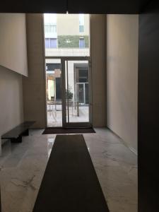 a hallway of a building with a large window at Corso Como New Building Apartment in Milan