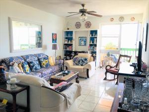 a living room with couches and a ceiling fan at Opp Sea, Beach, Restaurants 5b - 2bed 2 bath 5B Hastings Tower in Bridgetown
