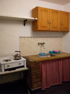 a kitchen with a stove and a sink at La Higuerita in Capilla del Monte