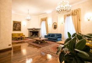 a living room with a couch and a fireplace at Grand Hotel Italia in Orvieto