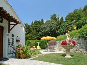 a garden with a statue of a woman in a fountain at Le Hameau in Saint-Paul-de-Vence