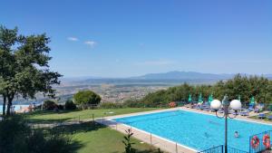 a swimming pool with a view of a resort at Camping Barco Reale in Lamporecchio