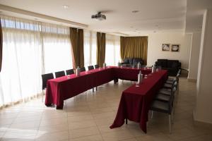 a large room with a long table and chairs at Hotel Villa Cibele in Catania