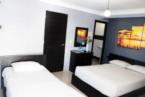 Llit o llits en una habitació de Hotel Merey