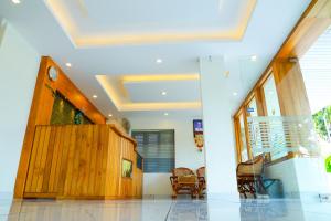 a living room with a wooden door and chairs at Anna Residency in Nedumbassery