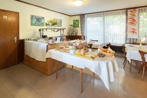 a dining room with a table with white table cloth at Hotel Hohe Flum in Schopfheim