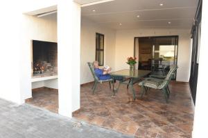 a man sitting at a table in a house at Jubel n Juig Self Catering in Dwarskersbos