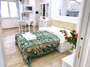 a bedroom with a bed and a dining room with a table at CASANOVA - Indipendent Luxury Apartment in Vibo Valentia