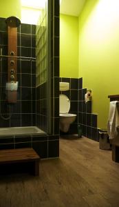 a bathroom with a toilet and a sink and a tub at La Thébaïde in Saint-Amour