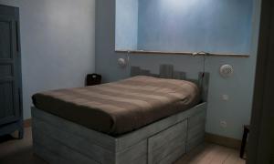 a bedroom with a bed in a room at La Thébaïde in Saint-Amour
