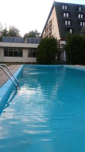 a large blue swimming pool in front of a building at Hotel Bitov in Bítov