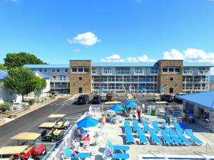 an aerial view of a resort with chairs and umbrellas at Put-in-Bay Waterfront Condo #103 in Put-in-Bay