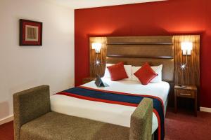 A bed or beds in a room at Mercure Newbury West Grange Hotel