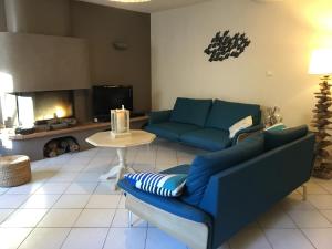 a living room with a couch and a fire place at Villa Batelo in Six-Fours-les-Plages