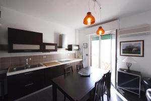 a kitchen with a table and a dining room at Casa sul mare in Isola delle Femmine