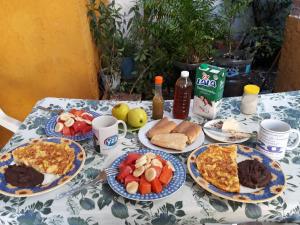 a table with plates of breakfast food on it at Casa Azul in Valladolid