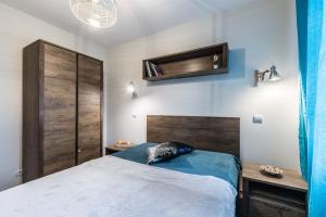 Posteľ alebo postele v izbe v ubytovaní Apartament WILDA