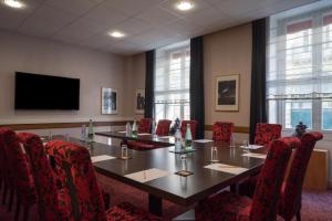 a conference room with a long table and chairs at Hotel Voltaire Opera Nantes Centre in Nantes