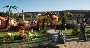 a childrens playground with a ride in a park at Apartman Kyjev in Podhájska