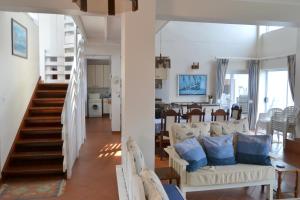 a living room with a couch and a dining room at Nine-ohh Skuitbaai in Eersterivierstrand