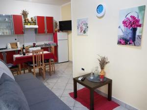 a living room and kitchen with a couch and a table at Apartments Davor in Umag