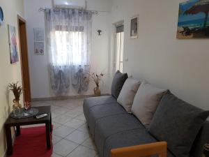 a living room with a gray couch and a table at Apartments Davor in Umag