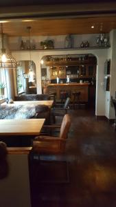 a living room with a table and chairs and a bar at Pension Abshoff in Meschede