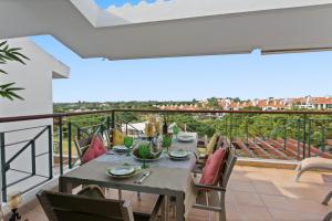 a patio with a table and chairs on a balcony at Superb, relaxing and tranquil 3 bed Apartment in Central Algarve in Vilamoura