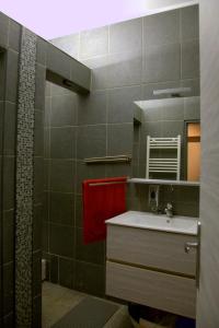 a bathroom with a sink and a red towel at Studio apartman - Park - in Osijek