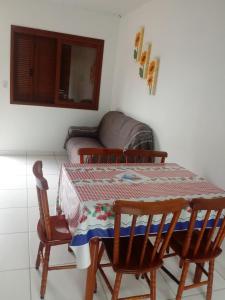 a room with a table and two chairs and a couch at Pousada Recanto Rocha in Arambaré