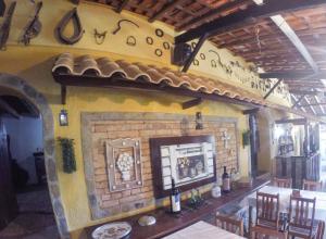 a room with a brick fireplace in a restaurant at Hotel Fazenda dos Anjos in Cambuquira
