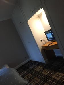 a room with a desk with a computer on it at Water side flat in Hawick