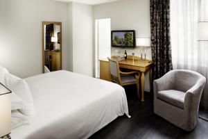a hotel room with a bed and a desk and a chair at EasyRooms ai Monti in Locarno