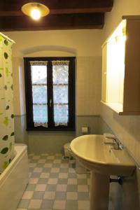 a bathroom with a sink and a toilet and a window at Agriturismo La Staffa in Valeggio sul Mincio