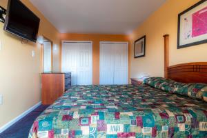 a bedroom with a bed and a flat screen tv at Master Suites Hotel in Waldorf