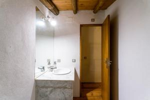 a bathroom with a sink and a mirror at Antigua Panadería de Valdelarco, chimenea con horno 2 Hab 4 pers mas 2 max in Valdelarco +56 photos