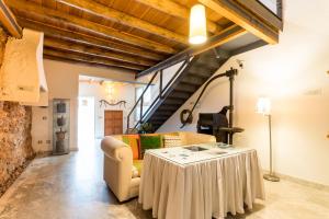 a living room with a table and a couch at Antigua Panadería de Valdelarco, chimenea con horno 2 Hab 4 pers mas 2 max in Valdelarco