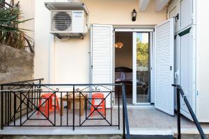 a balcony with a table and chairs and a door at Doris House by GuestCorfu in Corfu