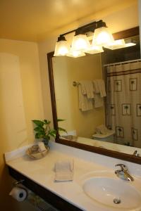a bathroom with a sink and a large mirror at Hotel on the Cay in Christiansted