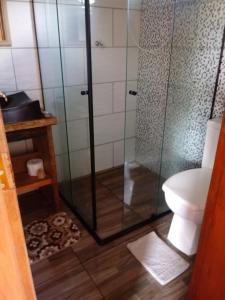 a bathroom with a shower and a toilet at Chalés Alvorada in Praia Grande +72 photos