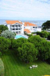 an aerial view of a building with a pool and trees at Anne de Bretagne in La Plaine-sur-Mer