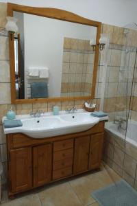 a bathroom with a sink and a mirror and a tub at La Roche Bellevue in Luynes +39 photos