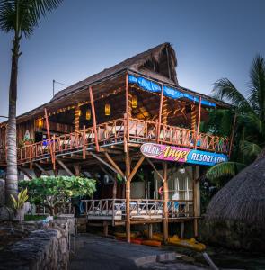 a building with a restaurant with a deck at Blue Angel Resort in Cozumel