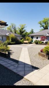 a walkway in a yard with a house at Kilcloon Holiday Homes & Private Rooms in Maynooth