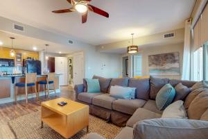 a living room with a couch and a kitchen at Bahia Condos in Destin