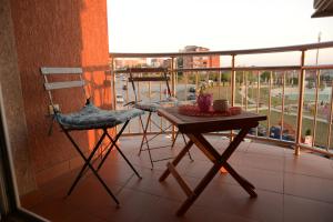 a balcony with a table and a chair on a balcony at Hostel Tuba in Pristina