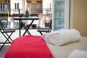 a white pillow and a table on a balcony at Gregory House in Rome