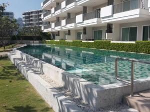 a swimming pool in front of a building at The Sea Condominium 267/50 in Sam Roi Yot